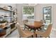 Cozy dining room with stylish decor, shelving, and a view of the backyard pool at 15217 Octavia Ln, Odessa, FL 33556