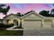 Inviting front exterior showcasing lush landscaping, a well-maintained lawn and a charming architectural design at 15217 Octavia Ln, Odessa, FL 33556