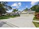 Well-maintained home featuring a spacious driveway, a three-car garage and mature landscaping at 15217 Octavia Ln, Odessa, FL 33556