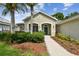 Charming home featuring a well-manicured lawn, lush landscaping, and an inviting entrance at 15217 Octavia Ln, Odessa, FL 33556