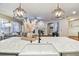 Kitchen island with marble countertops and decorative lighting opens to spacious living area with fireplace at 15217 Octavia Ln, Odessa, FL 33556