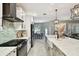 Well-lit kitchen showcases stainless steel appliances, stylish backsplash, and an island with ample counter space at 15217 Octavia Ln, Odessa, FL 33556