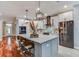 Modern kitchen with stainless steel appliances, quartz countertops, and a large center island with seating at 15217 Octavia Ln, Odessa, FL 33556