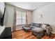 Cozy living room with hardwood floors, neutral paint, and stylish sectional couch at 15217 Octavia Ln, Odessa, FL 33556