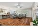 Open-concept living room with large windows, hardwood floors, and views of the kitchen area at 15217 Octavia Ln, Odessa, FL 33556