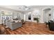 Spacious living room with hardwood floors, fireplace, and plentiful natural light from large windows at 15217 Octavia Ln, Odessa, FL 33556