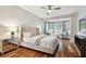 Spacious main bedroom offers a cozy sitting area with a ceiling fan and bright windows at 15217 Octavia Ln, Odessa, FL 33556