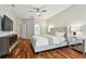 The main bedroom boasts a ceiling fan and plush furnishings atop hardwood floors at 15217 Octavia Ln, Odessa, FL 33556