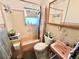 Compact bathroom with vintage pink tiling, combined shower and tub, and functional fixtures at 1605 Logan St, Clearwater, FL 33755
