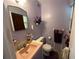 Cozy bathroom featuring a pink sink and toilet, with unique lavender walls at 1605 Logan St, Clearwater, FL 33755