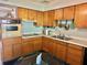 Functional kitchen with wooden cabinets, stainless sink, and compact design at 1605 Logan St, Clearwater, FL 33755