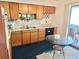 Functional kitchen with wooden cabinets, stainless sink, and adjacent dining area at 1605 Logan St, Clearwater, FL 33755