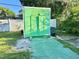 Exterior view of a backyard storage shed with a green painted door and side access at 1605 Logan St, Clearwater, FL 33755