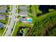 Drone shot of a beautiful home with a pool, solar panels, and a tranquil pond in the backyard at 19636 Long Lake Ranch Blvd, Lutz, FL 33558