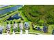 Stunning aerial view of a home with a private pool backing up to a pond and lush greenery at 19636 Long Lake Ranch Blvd, Lutz, FL 33558