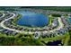 Aerial view of a lakeside community showcasing the beautiful homes and community lake at 19636 Long Lake Ranch Blvd, Lutz, FL 33558