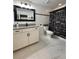 Modern bathroom with a vanity, black fixtures, and decorative shower curtain, creating a stylish and functional space at 19636 Long Lake Ranch Blvd, Lutz, FL 33558