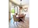 Dining area with sliding glass doors to the backyard, and contemporary lighting at 19636 Long Lake Ranch Blvd, Lutz, FL 33558