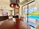Cozy dining area adjacent to the sparkling pool, with a contemporary light fixture at 19636 Long Lake Ranch Blvd, Lutz, FL 33558