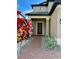 Inviting front entrance with a brick pathway, manicured landscaping, and a stylish front door with wreath at 19636 Long Lake Ranch Blvd, Lutz, FL 33558