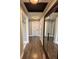Hallway with hardwood floors, neutral paint, and recessed lighting, creating a seamless flow between rooms at 19636 Long Lake Ranch Blvd, Lutz, FL 33558