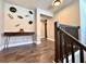 Upstairs hallway with contemporary art and a wood console table at 19636 Long Lake Ranch Blvd, Lutz, FL 33558