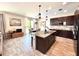 Modern kitchen featuring dark wood cabinets, granite countertops, stainless steel appliances, and an island at 19636 Long Lake Ranch Blvd, Lutz, FL 33558