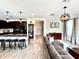 Open-concept living room with an island, dark wood cabinets, modern lighting, and stylish decor at 19636 Long Lake Ranch Blvd, Lutz, FL 33558