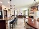 Open-concept living space featuring granite counters, seating, and hardwood floors at 19636 Long Lake Ranch Blvd, Lutz, FL 33558