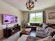 A modern Gathering room with an oversized sectional, decor, and a large window at 19636 Long Lake Ranch Blvd, Lutz, FL 33558