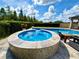 Stunning pool area featuring a circular spa, perfect for relaxation and entertaining at 19636 Long Lake Ranch Blvd, Lutz, FL 33558