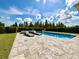 Inviting pool and spa area with comfortable lounge chairs and manicured lawn at 19636 Long Lake Ranch Blvd, Lutz, FL 33558