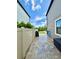 Property side yard with paved walkway, fence, and view of the backyard at 19636 Long Lake Ranch Blvd, Lutz, FL 33558