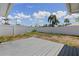 Spacious backyard with a white fence and wood patio, perfect for outdoor living at 2 79Th S St, St Petersburg, FL 33707
