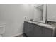 Bathroom featuring gray vanity with dual sinks, granite counters, and a large mirror at 2 79Th S St, St Petersburg, FL 33707
