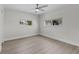 Neutral bedroom features wood-look flooring and large windows with blinds at 2 79Th S St, St Petersburg, FL 33707