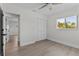 Bedroom with closet, neutral walls, ceiling fan, and wood-look flooring at 2 79Th S St, St Petersburg, FL 33707