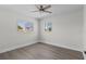 Bedroom with neutral walls, wood-look flooring, and natural light from the windows at 2 79Th S St, St Petersburg, FL 33707