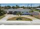 Charming single-story home with a circular driveway and nicely landscaped front yard at 2 79Th S St, St Petersburg, FL 33707