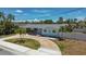 Charming single-story home with a circular driveway and nicely landscaped front yard at 2 79Th S St, St Petersburg, FL 33707