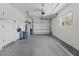 Clean garage with white walls, an automatic door, and utility shelving at 2 79Th S St, St Petersburg, FL 33707