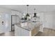 Bright kitchen with granite island, stainless appliances, and stylish pendant lighting at 2 79Th S St, St Petersburg, FL 33707