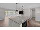 Open-concept kitchen with a large island, modern appliances, and wood flooring at 2 79Th S St, St Petersburg, FL 33707