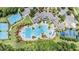 Aerial view of community with pools, tennis courts, and playgrounds, showcasing its amenities at 20302 Noble Oak Pl, Tampa, FL 33647
