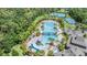 Aerial view of a community featuring pools, tennis courts, and lush landscaping at 20302 Noble Oak Pl, Tampa, FL 33647