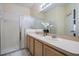 Bright bathroom with dual sinks, ample counter space, and a glass-enclosed shower at 20302 Noble Oak Pl, Tampa, FL 33647