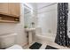 Cozy bathroom features a pedestal sink, tub-shower combo, and tiled flooring for a clean aesthetic at 20302 Noble Oak Pl, Tampa, FL 33647