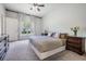 Bright bedroom featuring carpet floors and large windows, creating a cozy and well-lit space at 20302 Noble Oak Pl, Tampa, FL 33647