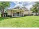 Well-manicured lawn leading to a charming home with a cozy front porch at 20302 Noble Oak Pl, Tampa, FL 33647