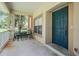 Inviting front porch with seating and a blue front door at 20302 Noble Oak Pl, Tampa, FL 33647